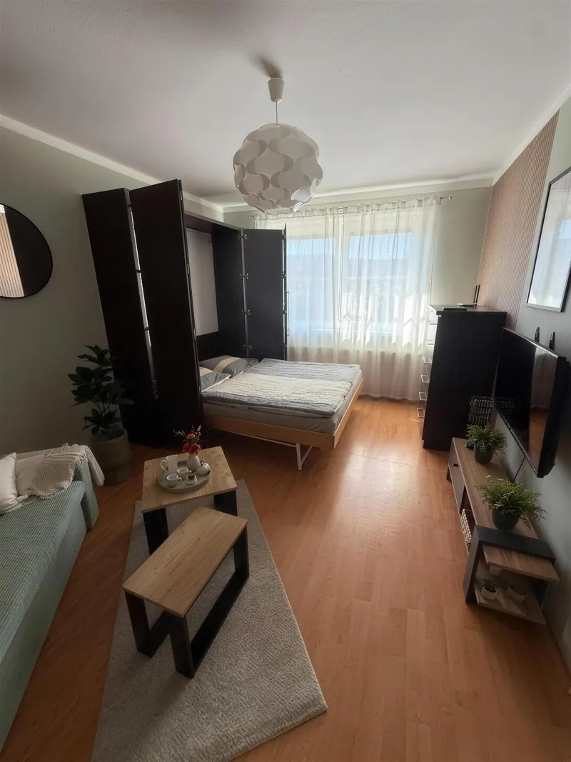 Stejný pokoj večer s rozloženou manželskou postelí